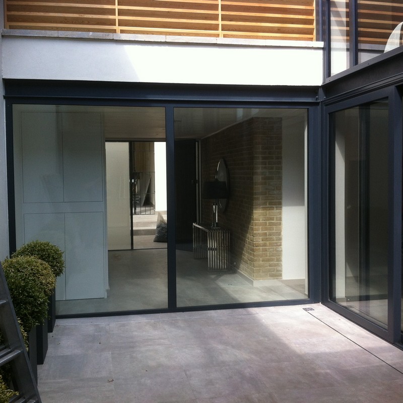 Floor-to-ceiling sliding doors opening to courtyard in Thame